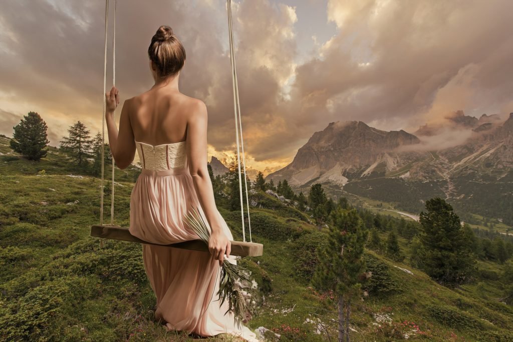 Swinging in the Rockies, woman on swing in mountains