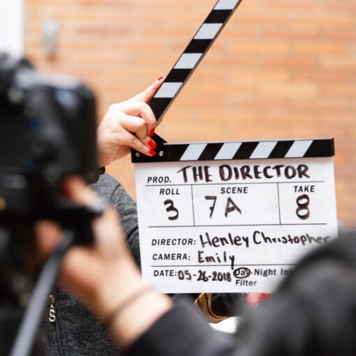 man holding clapper board