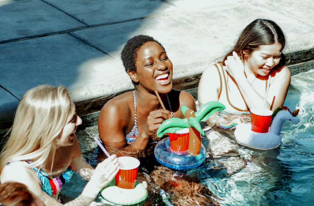 women drinking in pool