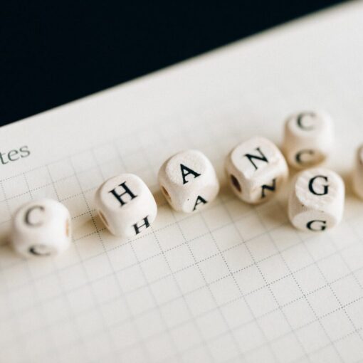 a close up shot of letter dice on an open notebook