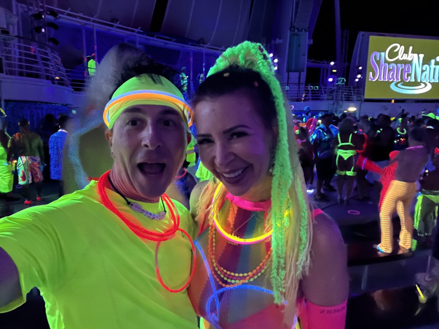 Ed and Phoebe in glow night costumes on the 2021 Bliss Cruise Swinger Cruise