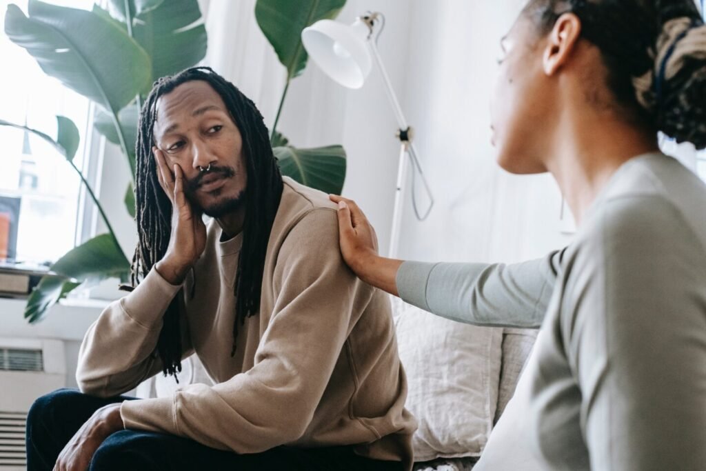 man and woman having a conversation in the living room