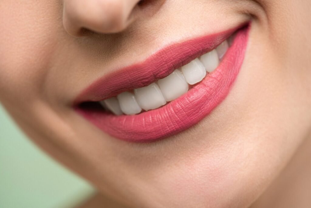 woman smiling with teeth, lips with pink lipstick