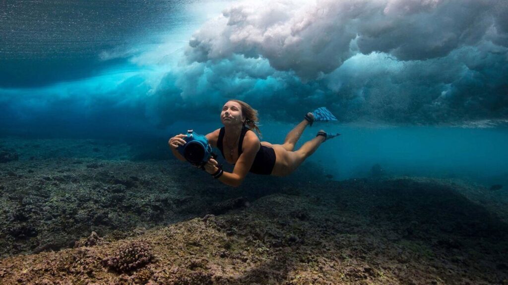 Diver exploring underwater coral reef.