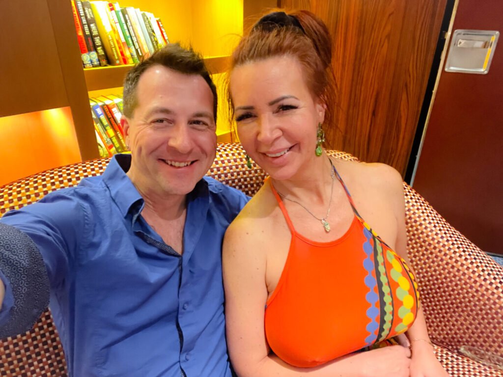 Ed & Phoebe sitting in the lounge on the Bliss Cruise