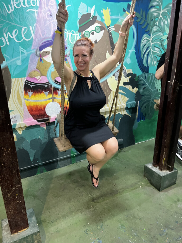 Woman on swing in colorful setting.